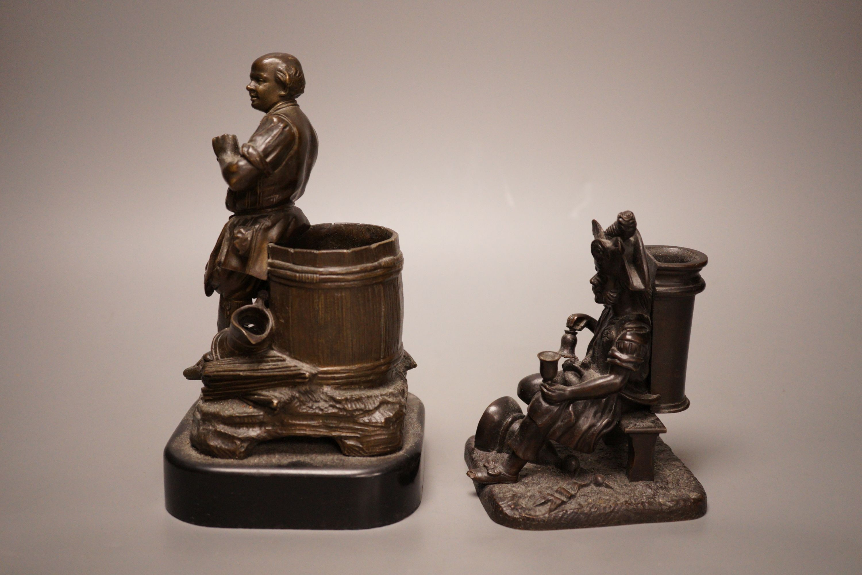 Two late 19th century bronze spill vases, cast as a tradesman and a war veteran. Tallest 19cm